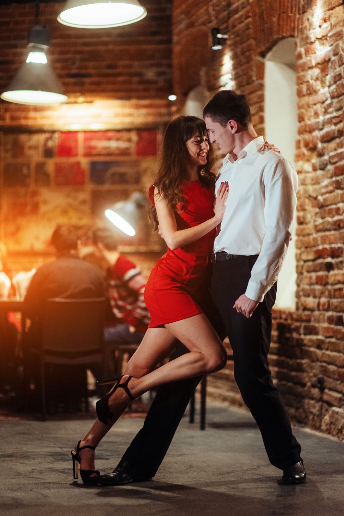 Salsa dance couple, woman in a red dress